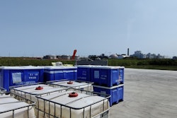 Dry and wet corn byproduct containers outside Innovafeed’s pilot facility in Decatur, Illinois, within sight of an ADM wet corn processing facility.