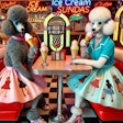 Dall·e 2024 12 03 11 35 28 A Kitschy 1950s Scene Featuring Two Poodles Eating Ice Cream Sundaes In A Classic American Diner The Diner Is Styled With Vibrant Chrome Accents, Neo