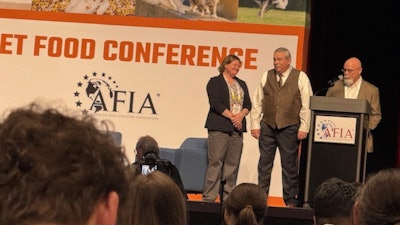 Jessica Starkey, Ph.D., and Charles Starkey, Ph.D. (right) presented AFIA's 2025 Friend of Pet Food Award to Eric Altom, Ph.D. (center).
