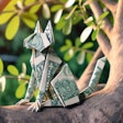 Dall·e 2024 05 23 16 01 20 An Origami Cat Made From Dollar Bills, Sitting In A Tree The Tree Should Have Detailed Branches And Leaves, And The Origami Cat Should Be Clearly Vis