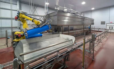 The automated Hiperbaric 525i HPP production line at Instinct Pet Food includes both the 525i in-pack HPP machine and a fully automated HPP robotic arm.