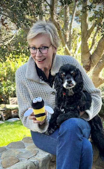 Actress Jane Lynch poses with her dog and the iconic Busy Bee toy from Best in Show.