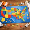 A Jigsaw Puzzle Of The United States Empty Pet Food Packages And Legal Documents Are Scattered Around The Puzzle