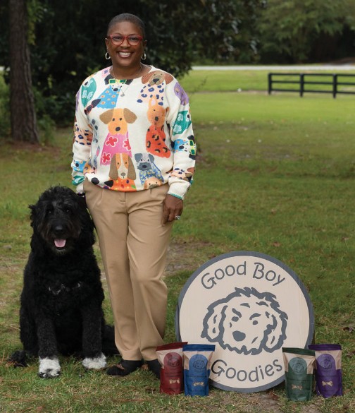 Good Boy Goodies founder ArrKeicha Danzie, pictured here with company mascot Mr. Chubb, is carving a unique path in pet treats by targeting innovative retail spaces, including airport concourses, rest stops, specialty boutiques and farmers markets.