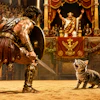 Dramatic 1930s Cinema Frame Of A Gladiator In An Arena He Faces Off Against A Cute Little Kitten, As If It Were A Lion