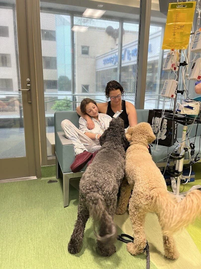 St. Louis Children's Hospital patient Molly O’Keefe with her dogs Sally and Cocoa in Purina Family Pet Center.