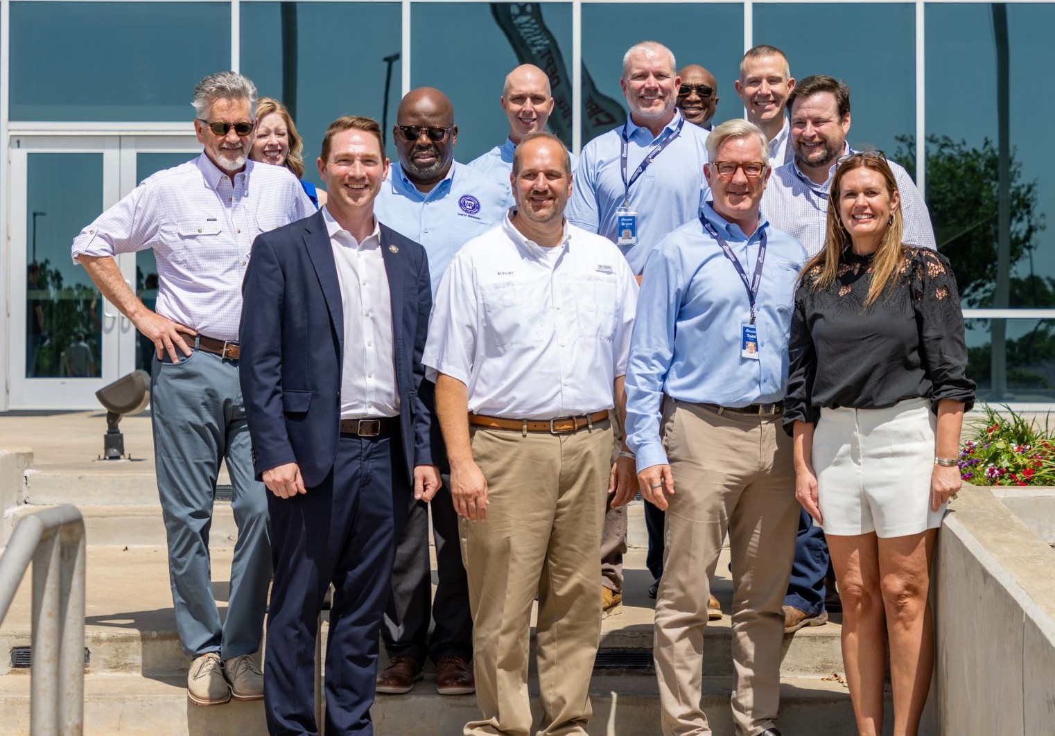 Simmons Foods personnel stand with Arkansas Gov. Sarah Huckabee Sanders.