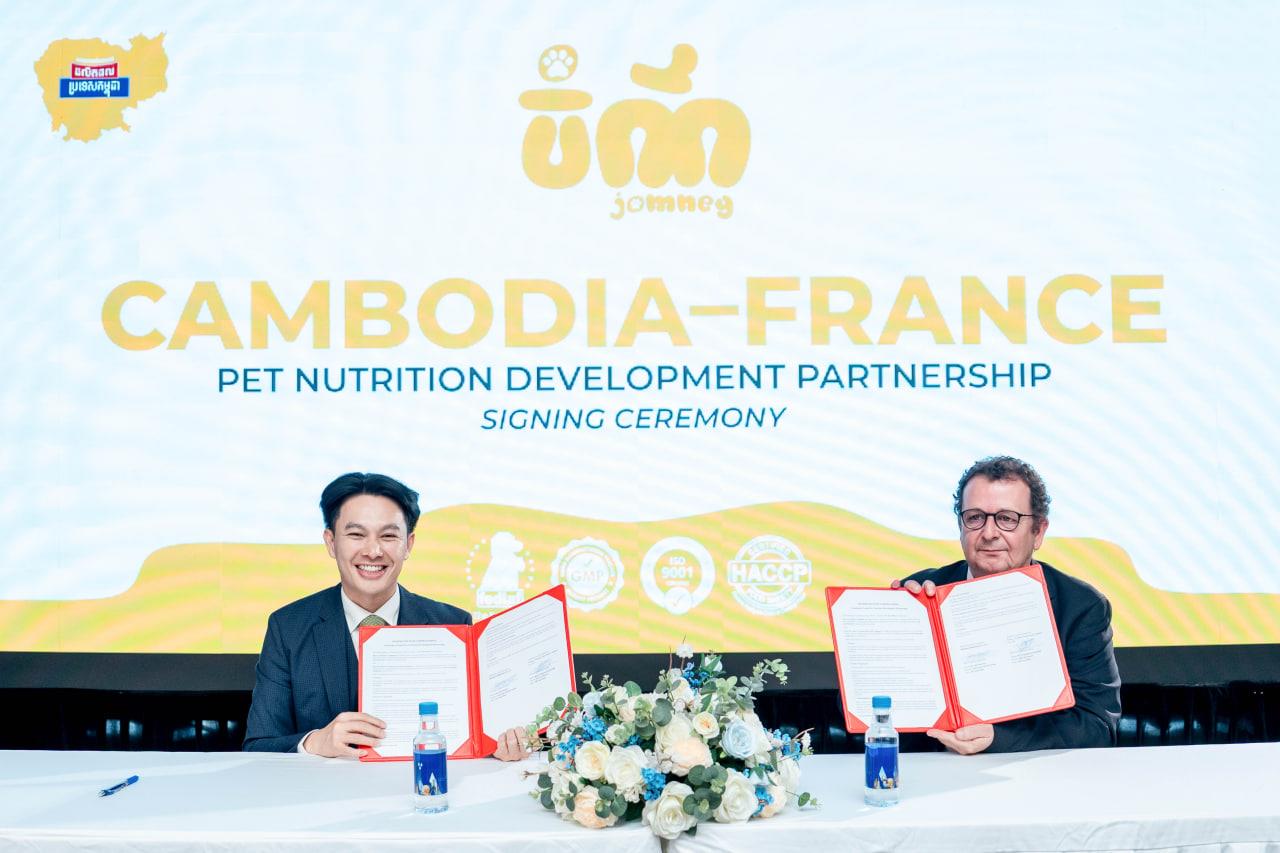 Two men sign partnership agreement at Cambodia-France pet nutrition development signing ceremony