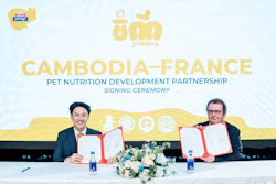 Two men sign partnership agreement at Cambodia-France pet nutrition development signing ceremony