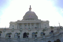 United States Capitol Building with white dome and classical columns under blue sky with clouds