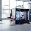 SORMIC industrial automated manufacturing machine with red and black frame in modern facility with large windows