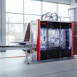 SORMIC industrial automated manufacturing machine with red and black frame in modern facility with large windows