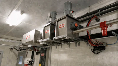 Industrial WEDA vacuum lifting systems mounted on ceiling rails in warehouse facility