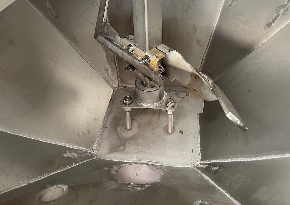 Overhead view of ceiling fan motor assembly with metal blades and mounting hardware