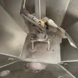 Overhead view of ceiling fan motor assembly with metal blades and mounting hardware