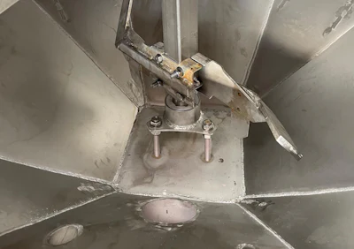 Overhead view of ceiling fan motor assembly with metal blades and mounting hardware
