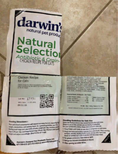 Darwin's Natural Selection chicken recipe pet food package with antibiotic and grain-free formula displayed open