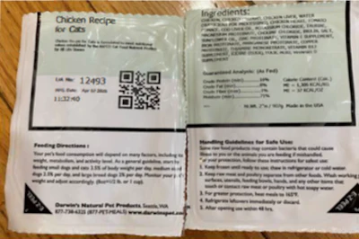 Four printed recipe and instruction cards for chicken dish displayed on wooden surface with QR code
