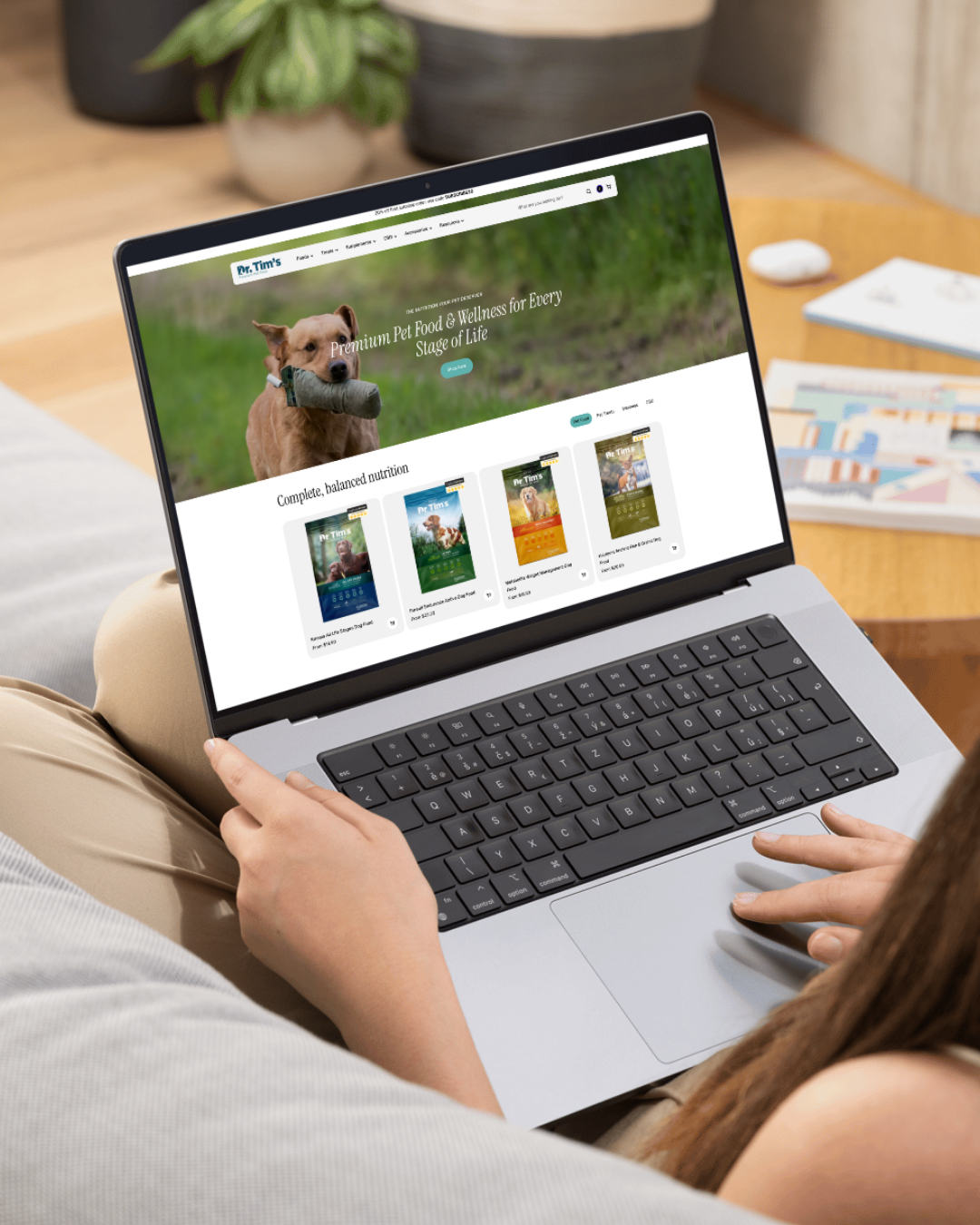 Pet food brand website displayed on laptop showing premium nutrition products with dog imagery and product catalog