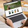 Pet food brand website displayed on laptop showing premium nutrition products with dog imagery and product catalog