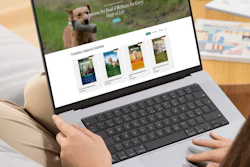 Pet food brand website displayed on laptop showing premium nutrition products with dog imagery and product catalog