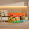 K9 Natural dog food packages displayed on modern kitchen counter with faucet and plants