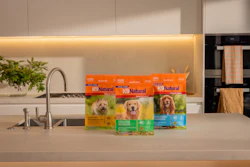 K9 Natural dog food packages displayed on modern kitchen counter with faucet and plants