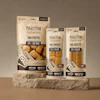 Mighty Paw Naturals yak cheese and puff dog treats in three package sizes displayed on a stone platform