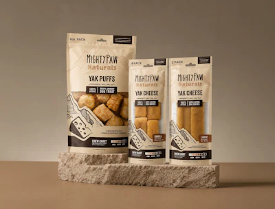 Mighty Paw Naturals yak cheese and puff dog treats in three package sizes displayed on a stone platform