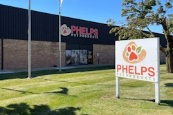 Phelps Pet Products storefront with white ground sign featuring orange paw print logo and building signage