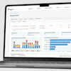 Equipment management dashboard showing alarm distribution charts and performance metrics on laptop screen