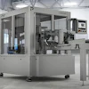 Industrial CNC precision manufacturing machine with gray enclosure and control panel in modern factory warehouse