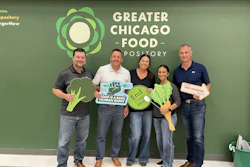 Five volunteers holding food advocacy signs at Greater Chicago Food Depository