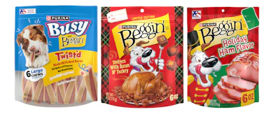 Three Purina dog treat packages: Busy Bone, Beggin' Stuffers, and Beggin' Holiday Ham Flavor varieties