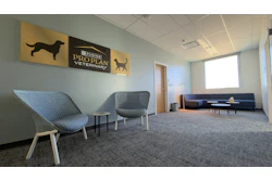 Modern veterinary clinic waiting room with Purina Pro Plan Veterinary signage and contemporary furniture