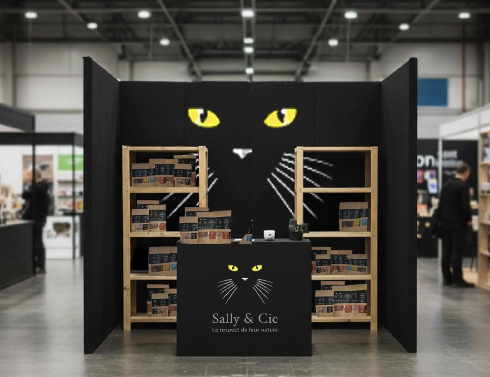 Sally & Cie retail booth with black cat face design and wooden shelving displaying products at a trade show
