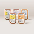 Five SMALLS cat food packaging containers displaying fresh poultry varieties in brown and colorful label designs