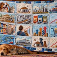 Blue and cream quilted blanket with panels depicting dogs, cats, pet food, shipping, retail shopping, and financial growth charts
